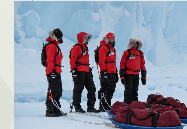 Ryan Grant on an Arctic expedition with teammates and sleds on the ice